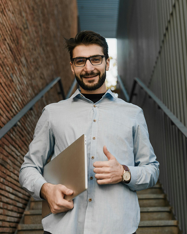 A Design Tech customer collecting a repaired laptop