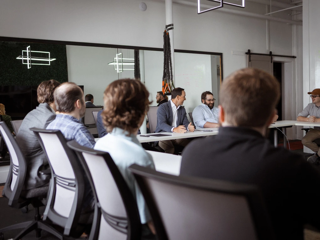 The Design Tech team meeting around a conference table at their Cramerton, NC office